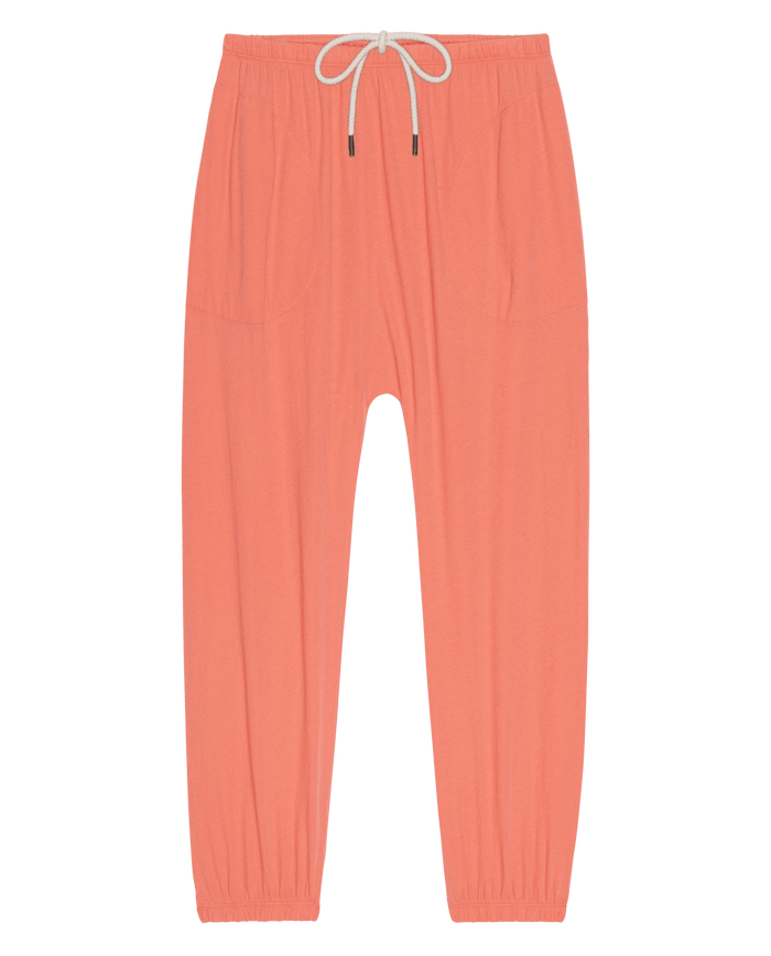 The Jersey Jogger Pant in Guava by THE GREAT. SU26 SEASONAL CORE features an elastic waistband with drawstring, two front pockets, and elastic cuffs, shown laid flat on a white background.