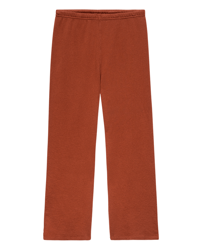 The Lap Sweatpant. Solid -- Brick by THE GREAT. F25 SEASONAL KNITS: rust-colored, wide cropped sweatpants with an elastic waistband, handcrafted in Los Angeles for comfort and style, shown laid flat on a white background.