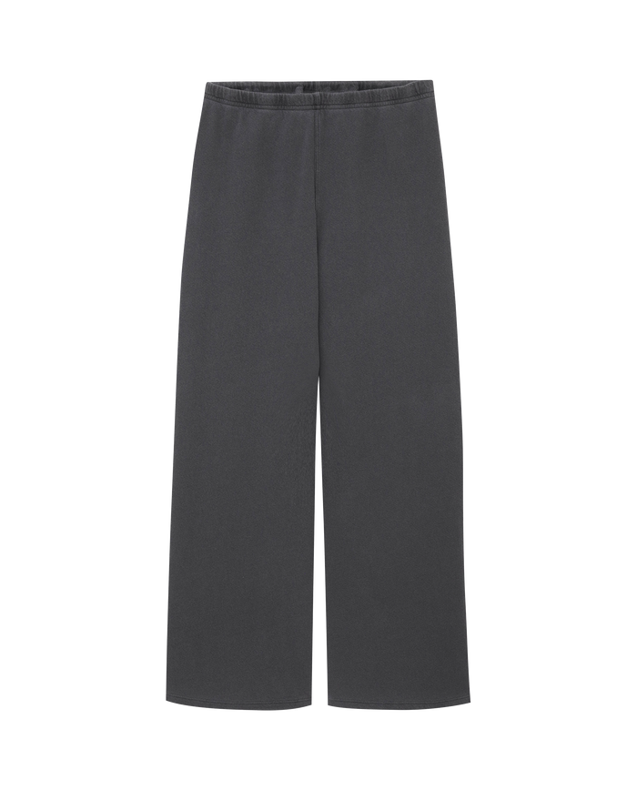 The Lap Sweatpant by THE GREAT. CORE KNITS features solid washed black wide-leg pants with an elastic waistband, offering classic comfort and effortless style.