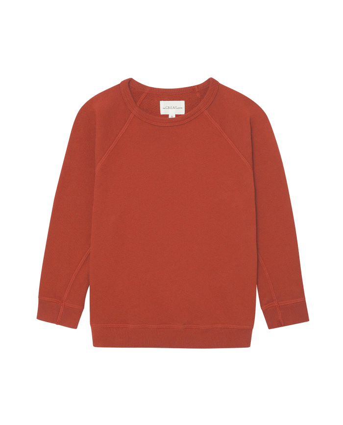 The Little College Sweatshirt—Solid Brick by THE GREAT. F25 LITTLES, a vintage-style, rust-colored long-sleeve top, is displayed on a white background.