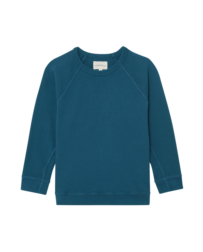The Little College Sweatshirt in solid Dark Slate by THE GREAT. F25 LITTLES is a long-sleeve crewneck vintage style with ribbed cuffs and hem, shown on a plain white background.