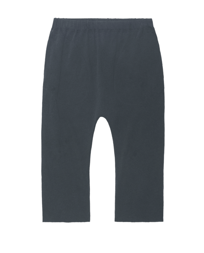 The Little Jersey Crop in Washed Navy by THE GREAT. LITTLE features a dark blue, loose-fitting design with an elastic waistband and two front pockets. These handcrafted jersey crop pants are made in L.A. and are shown against a plain white background.