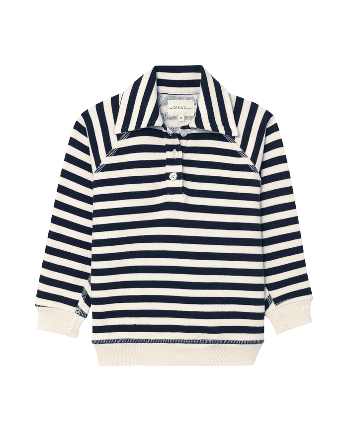 The Little Rugby Sweatshirt by THE GREAT. SP25 POLO LOUNGE LITTLE features a classic rugby style with navy sailor stripes, long sleeves, a collar, and three buttons on the front.