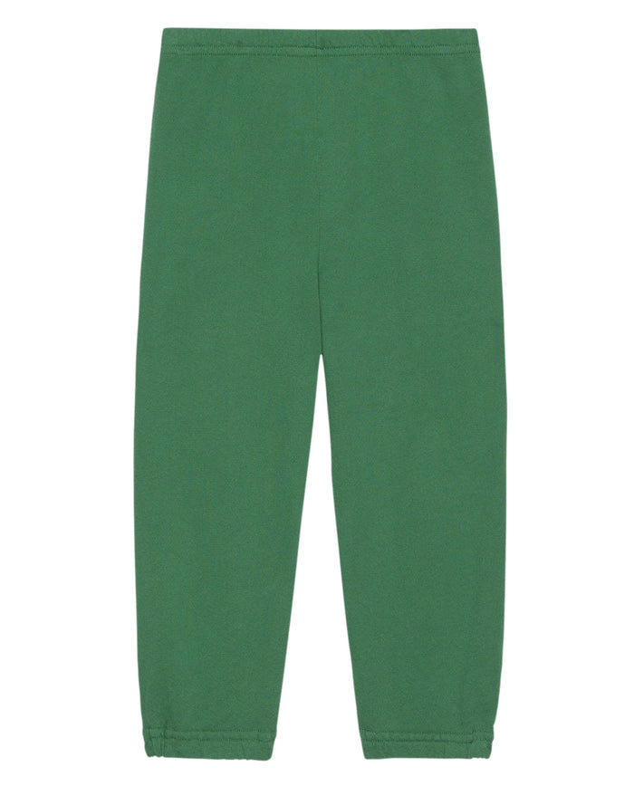A pair of The Little Stadium Sweatpant in Holly Leaf by THE GREAT. HOL 23 LITTLE, featuring an elastic waistband and elastic ankle cuffs, inspired by vintage athletic wear.