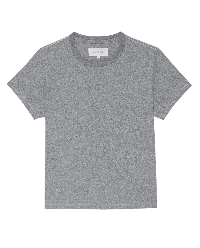 A classic heather grey short-sleeve t-shirt, The Little Tee. -- Heather Grey by THE GREAT. SP22 APRILCAP, is showcased against a white background. Perfect for a comfortable fit and ideal for layering, it exudes an effortlessly vintage vibe.