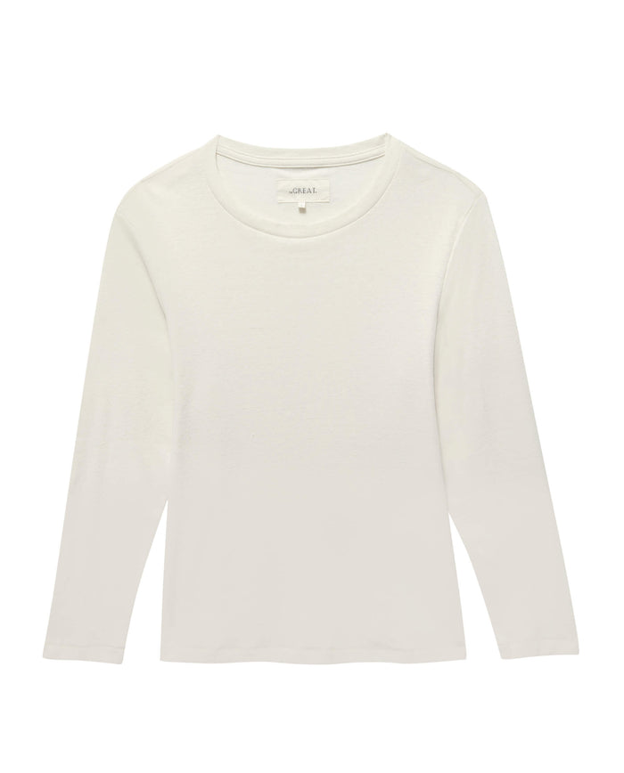 The Long Sleeve Recycled Slim Crew in Natural by THE GREAT. HOL 22 D1 is a supersoft, lightweight, plain white T-shirt with long sleeves and a round neckline. Made from a recycled cotton blend, it is displayed against a white background.