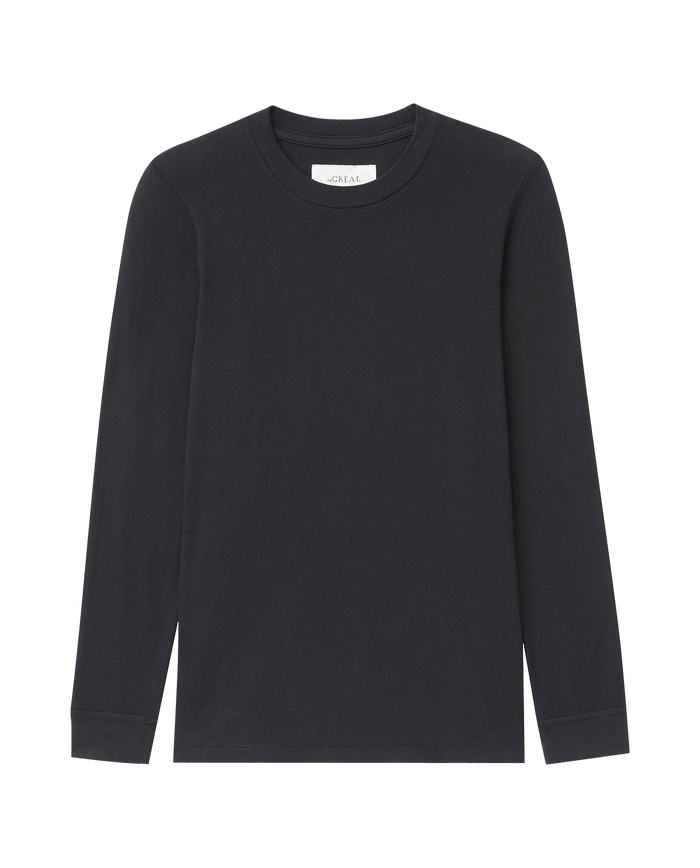 The Long Sleeve Slim Tee in Solid -- Almost Black by THE GREAT. F25 CORE KNITS is laid flat on a white background.