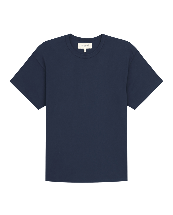 The Men's Boxy Crew in True Navy by THE GREAT. FALL 23 MEN is a wardrobe staple featuring a round neckline, crafted from 100% cotton, and showcased against a plain background.