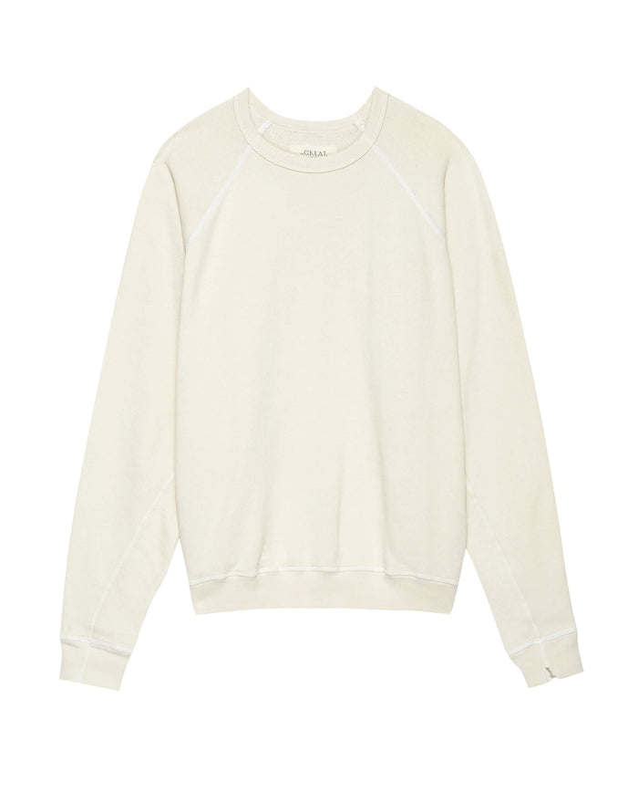 The Men's College Sweatshirt in Washed White from THE GREAT. MAN is laid flat against a white background, showcasing its vintage appeal with a timeless design and made from 100% cotton for ultimate comfort.