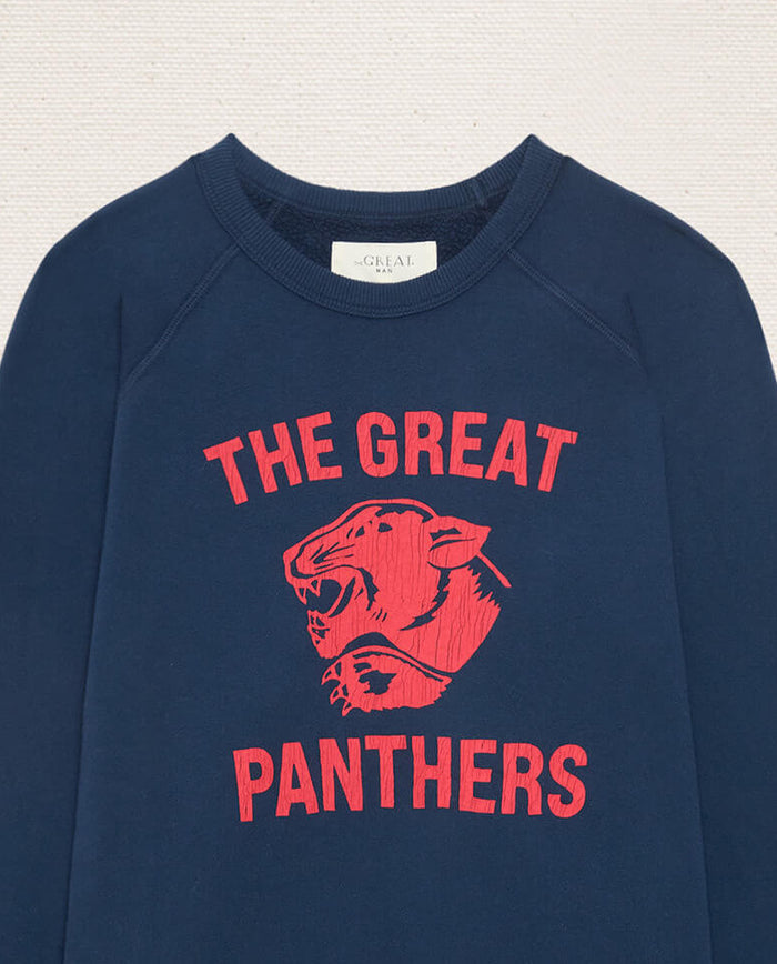 The Men’s College Sweatshirt w/ Growling Panther Graphic by THE GREAT. F26 D1, in True Navy, features “THE GREAT PANTHERS” in vibrant red lettering and a striking red panther head graphic on the front, evoking classic vintage college sweatshirt style.