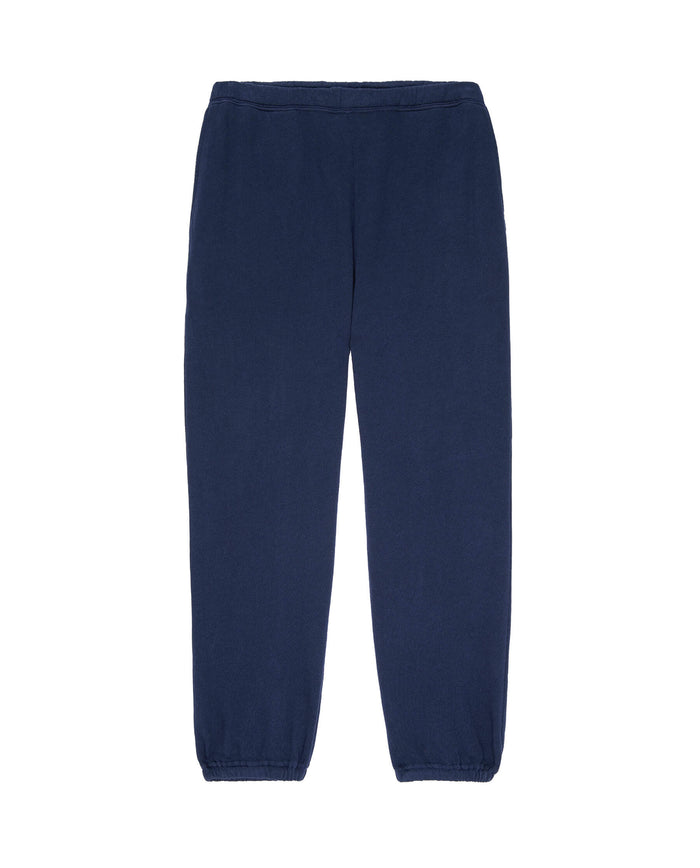 Image of The Men's Stadium Sweatpant in True Navy by THE GREAT. HOL 22 MEN, featuring an elastic waistband and cuffs, laid out flat on a white background.