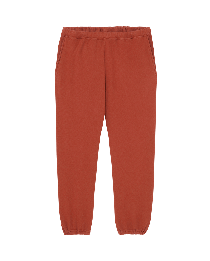 THE GREAT. F25 MENS The Men's Stadium Sweatpant in Brick—rust-colored, vintage-inspired men’s sweatpants with elastic waistband, side pockets, and elastic cuffs—shown laid flat on a white background.