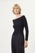 Woman wearing a blue off-shoulder sweater and black skirt on a white background