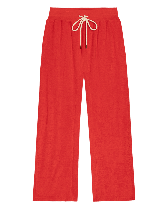 THE GREAT. SU26 The Micro Terry Horseshoe Sweatpant in Pimento features a bright red color, wide legs, an elastic waistband, and a beige drawstring tie, displayed on a white background.
