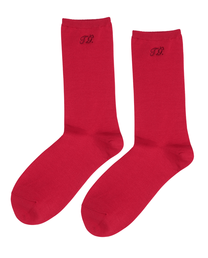 The Monogrammed Trouser Sock in Poppy Red by THE GREAT. F25 D1 ACCESSORIES features a "T.R." monogram near the top and is crafted from soft mercerized cotton.