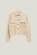 Beige jacket with button details on a light beige background