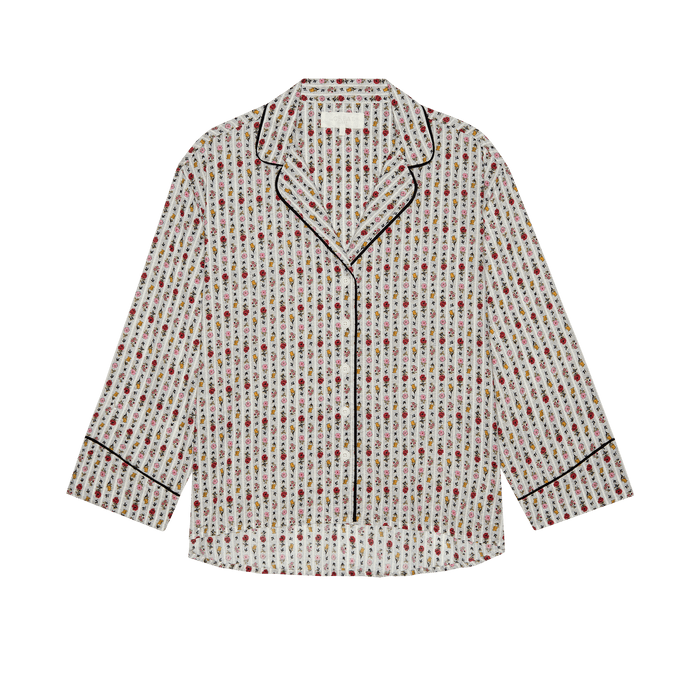 THE GREAT. PS26 SLEEP "The Pajama Shirt" in Ribbon Floral—a long-sleeve, button-up vintage top with small floral print and black piping on the collar, cuffs, and placket—displayed on a plain white background.