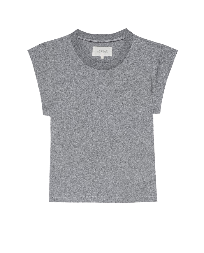 The Peak Shoulder Tee in Heather Grey by THE GREAT. FALL 22 KNITS features a crew neckline and a subtle pocket on the left chest, making it the perfect match for high-waisted denim.