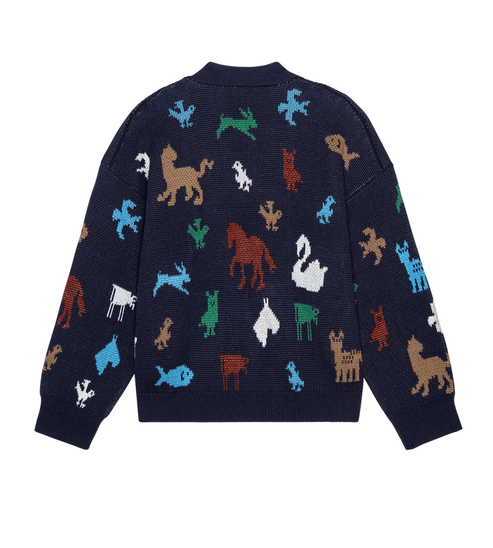 The Pictograph Slouch Cardigan in navy by THE GREAT. PS26 features colorful animal silhouettes—like lions, horses, swans, and dogs—scattered across the back.