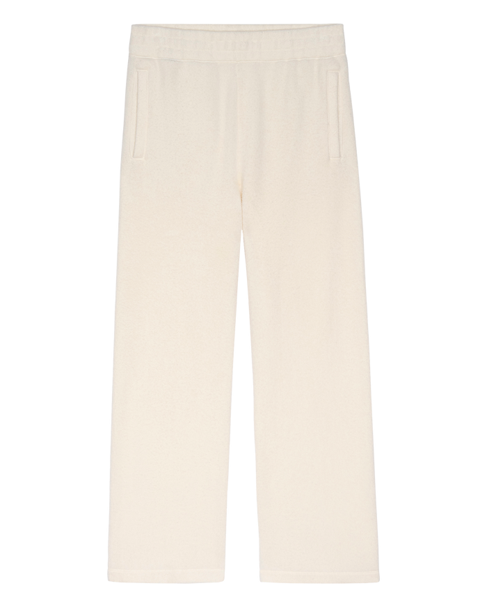 The Plush Victory Sweatpant in Washed White from THE GREAT. H25 TEDDY FLEECE features a straight-leg cut, elastic waistband, and side pockets, handcrafted in L.A., shown on a white background.