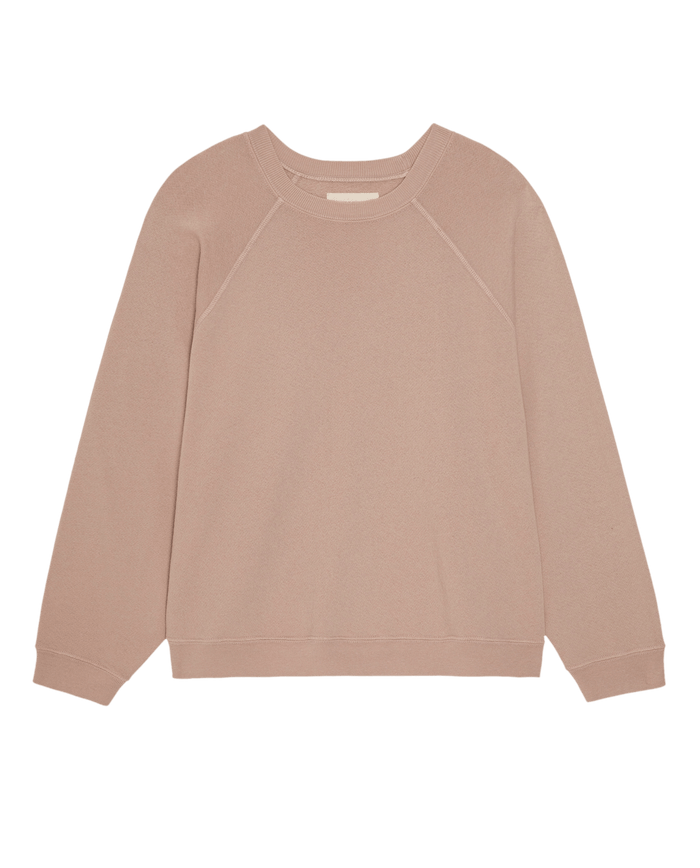 The Rehearsal Sweatshirt in Ballet Pink by THE GREAT. PF26 DANCER KNIT BODIES is a long-sleeve crewneck style, shown laid flat on a white background. It features a simple, plain design with ribbed cuffs, hem, and collar.