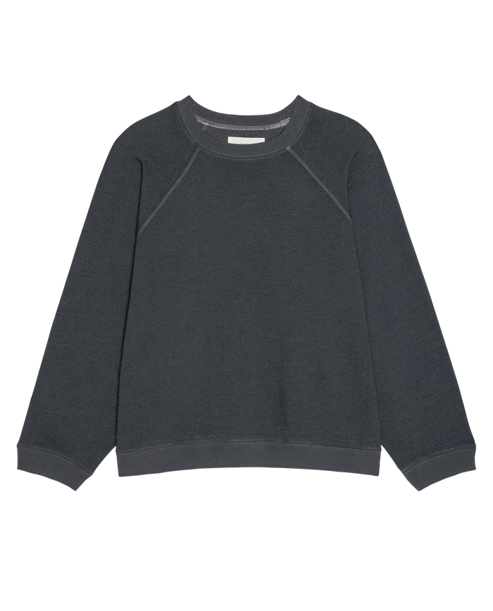 The Rehearsal Sweatshirt in Flat Charcoal by THE GREAT. PF26 DANCER KNIT BODIES, featuring a crewneck, long sleeves, and ribbed cuffs and hem, is laid flat on a plain white background.