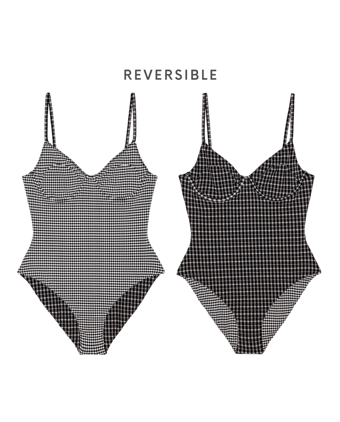 The Reversible Underwire One Piece by THE GREAT. SP26 SWIM features thin straps and a 1940s-inspired design, with black & cream check on one side and a smaller checkered pattern on the other—two swimsuits in one.