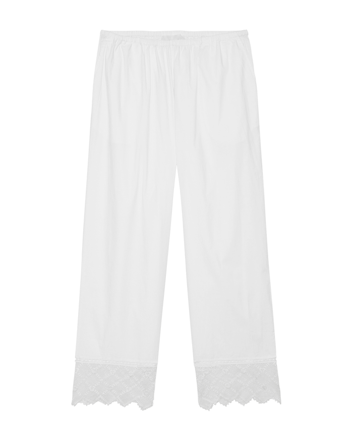 The Rosette Crochet Pant in cream by THE GREAT. SP26 D2 features a loose fit, elastic waistband, and delicate rosette crochet lace trim at the hem.