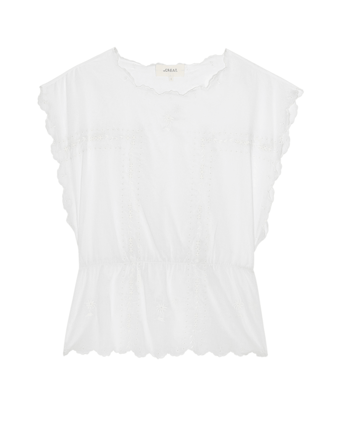 The Eyelet Tunic by THE GREAT. SU26: A white sleeveless top with scalloped edges, subtle embroidery, round neckline, and elasticized waist—ideal for chic summer style.