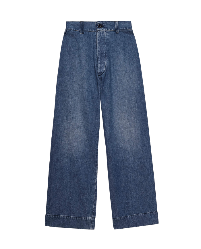 Introducing The Seafair Jean in Marina Wash by THE GREAT. PF24: blue denim jeans with an ultrahigh waist, wide legs, and a buttoned waistband, elegantly displayed against a white background.