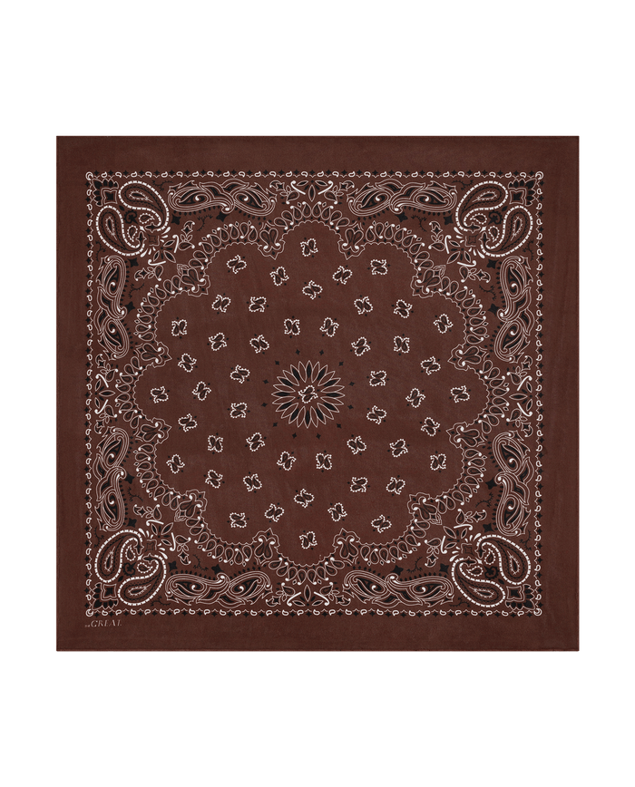 Introducing The Silk Bandana in Chocolate by THE GREAT. F26 COLLECTORS — a vintage-inspired accessory featuring a classic paisley and floral pattern, accented with intricate white and black designs along the edges and center. Crafted from lightweight silk, this bandana blends timeless style with everyday comfort.