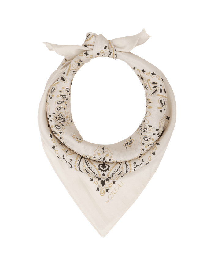 The Silk Bandana in cream by THE GREAT. F25 COLLECTORS features a lightweight silk paisley design, folded and knotted at the top, shown on a white background.