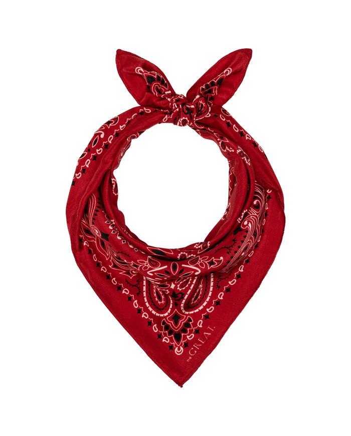 The Silk Bandana in True Red by THE GREAT. F25 COLLECTORS features a vintage paisley pattern, crafted from lightweight silk, tied in a knot at the top, and displayed on a white background.