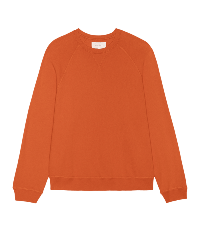 The Slouch Sweatshirt in Persimmon by THE GREAT. SP26 SEASONAL CORE features long sleeves, ribbed cuffs and hem, plus a V-stitch below the collar. Crafted in Los Angeles and inspired by classic vintage styles. Displayed on a white background.