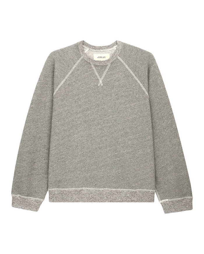 The Slouch Sweatshirt by THE GREAT. CORE KNITS in Varsity Grey showcases a vintage crewneck design with slouchy sleeves and ribbed cuffs and hem, elegantly displayed on a white background.