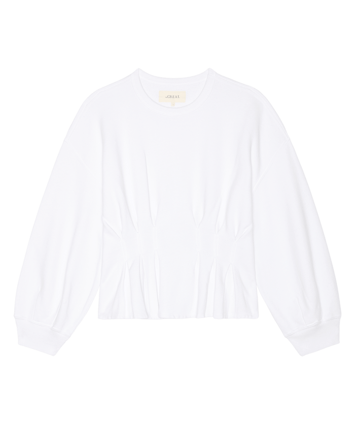 The Slouchy Corset Sweatshirt in True White by THE GREAT. SP26 DANCER BODIES features subtle waist gathers and a long-sleeve crewneck design, shown laid flat on a white background.