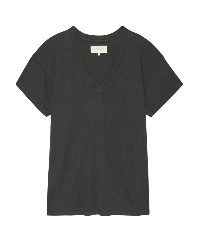 The Slouchy V-Neck Tee in Almost Black by THE GREAT. SP26 SEASONAL CORE, made from soft washed jersey with short sleeves, is shown laid flat on a white background.