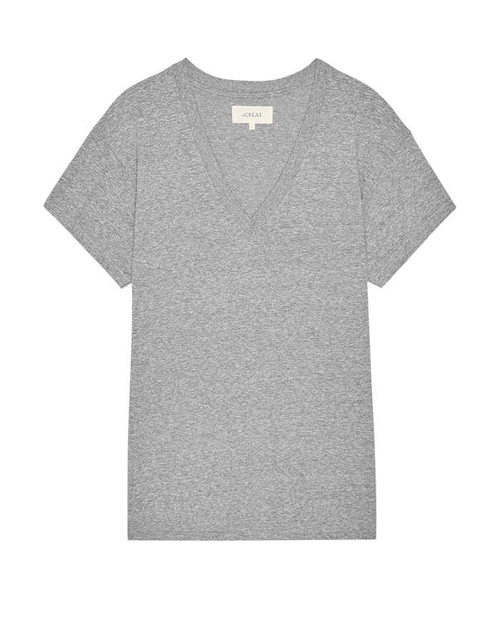 The Slouchy V-Neck Tee in Heather Grey by THE GREAT. SP26 SEASONAL CORE, a short-sleeve style made from soft washed jersey, is shown laid flat on a white background.