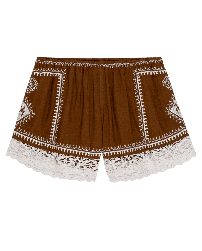 The Sparrow Short in Chocolate by THE GREAT. PF26 features white embroidered patterns and lace trim along the hem, shown flat against a white background.