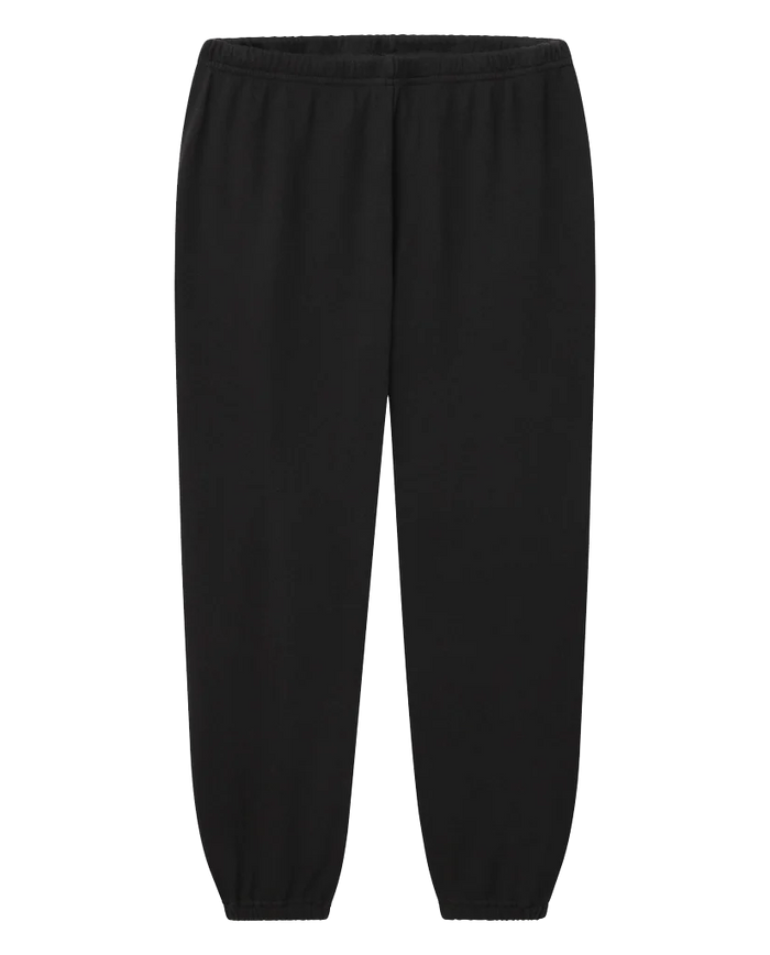 A pair of The Stadium Sweatpant. Solid in Almost Black by THE GREAT. CORE KNITS, featuring an elastic waistband and elastic cuffs at the ankles, perfect for achieving a vintage athletic look.