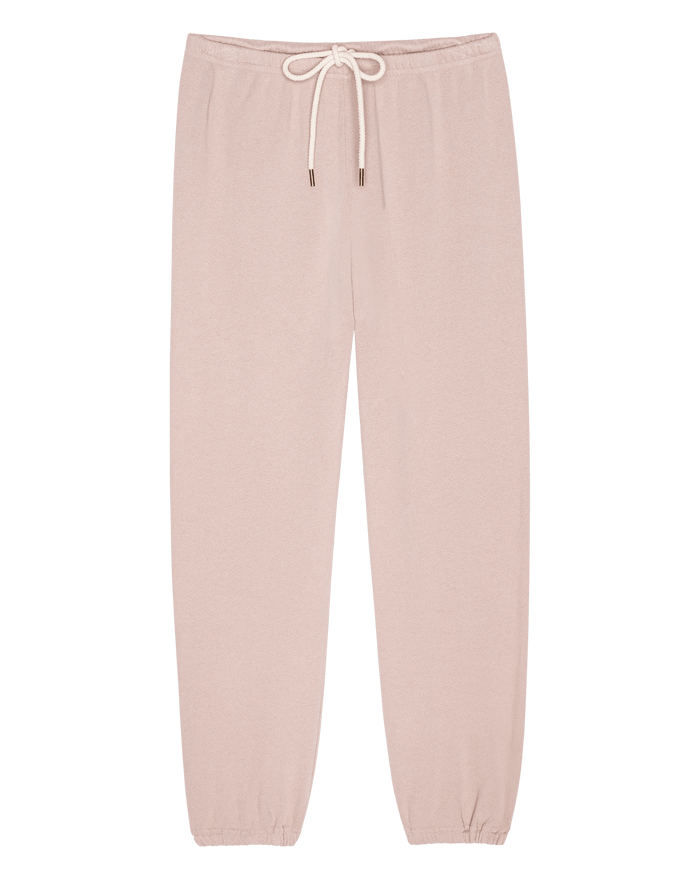 The Stadium Sweatpant in Ballet Pink by THE GREAT. F26 SEASONAL CORE features a light pink hue, handcrafted construction, an elastic waistband with a white drawstring, and elastic cuffs—effortlessly combining vintage sweatpants style with signature Los Angeles flair. Laid flat on a white background.