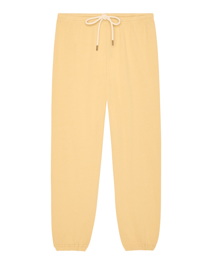 The Stadium Sweatpant by THE GREAT. SP26 SEASONAL CORE in Butter Yellow features a handcrafted design with an elastic waistband, white drawstring, and elastic cuffs, inspired by vintage athletic wear and shown laid flat on a white background.