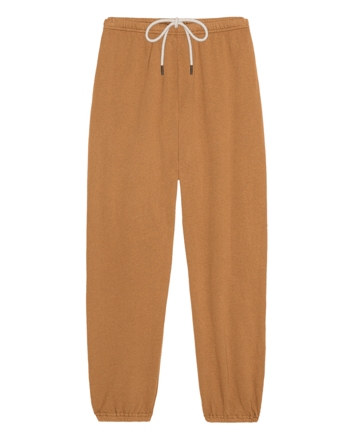 THE GREAT. SU26 SEASONAL CORE The Stadium Sweatpant in Solid Cork features an elastic waistband, white drawstring, and elastic cuffs, displayed flat on a white background.