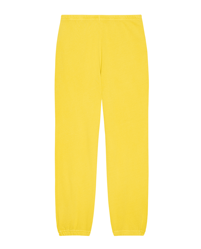 The Stadium Sweatpant in Daffodil by THE GREAT. SP25 KNITS features bright yellow color and elastic cuffs, ideal for athleisure, displayed on a white background.