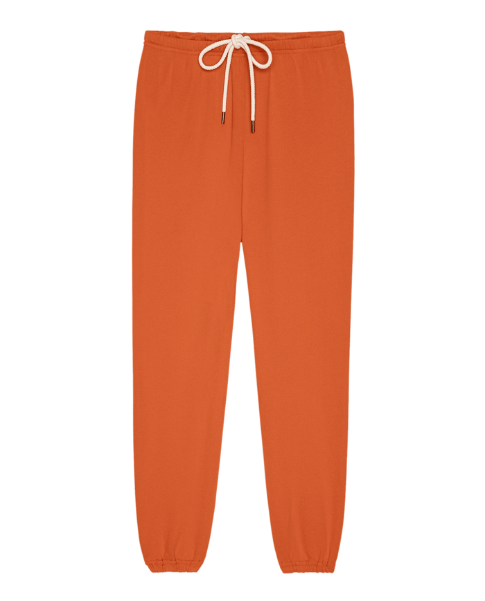The Stadium Sweatpant in Persimmon by THE GREAT. SP26 SEASONAL CORE—features an elastic waist, white drawstring, and elastic cuffs; vintage style, shown laid flat on a white background.