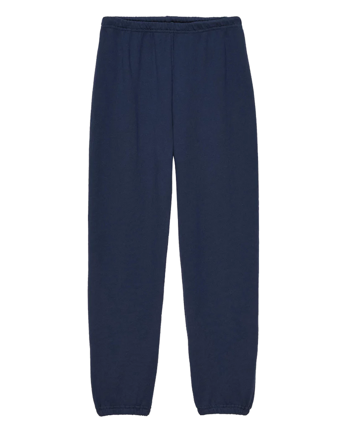 A pair of The Stadium Sweatpant. Solid -- True Navy from THE GREAT. FALL 23 KNITS, featuring an elastic waistband and elastic cuffs at the ankles, reminiscent of vintage athletic wear, displayed on a plain white background.