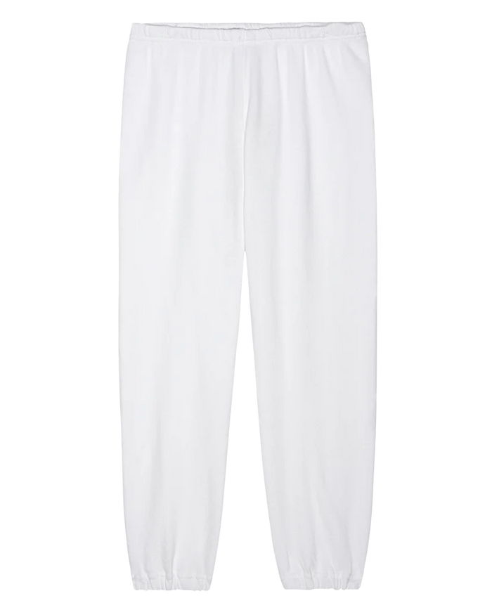 The Stadium Sweatpant from THE GREAT. FALL 24 KNITS is a tribute to vintage athletic wear, boasting an elastic waistband and cuffs. Handcrafted locally, these sweatpants are displayed against a white background in a stylishly plain True White.