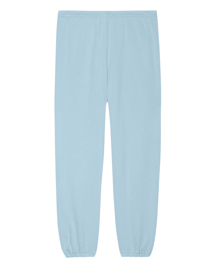 The Stadium Sweatpant. Solid -- Vista Blue by THE GREAT. SU25 SEASONAL KNITS features an elastic waistband and cuffs, laid flat for a relaxed look—perfect for casual wear or sporty style.
