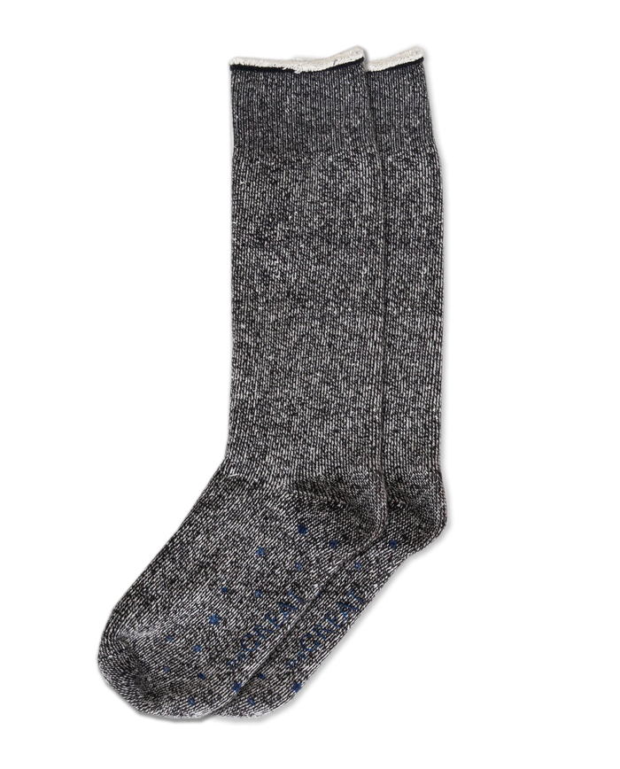 A gray speckled pair of THE GREAT.'s "The Sweatshirt Sock" in black, featuring a white trim, is presented against a black backdrop, highlighting premium quality in apparel.