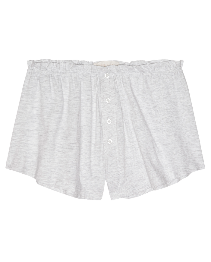 The Tap Short.. by THE GREAT. H25 SLEEP in Heather Grey features a gathered waistband, loose fit, button front, and ruffle detail—perfect for cozy nights in. Shown laid flat on a white background.